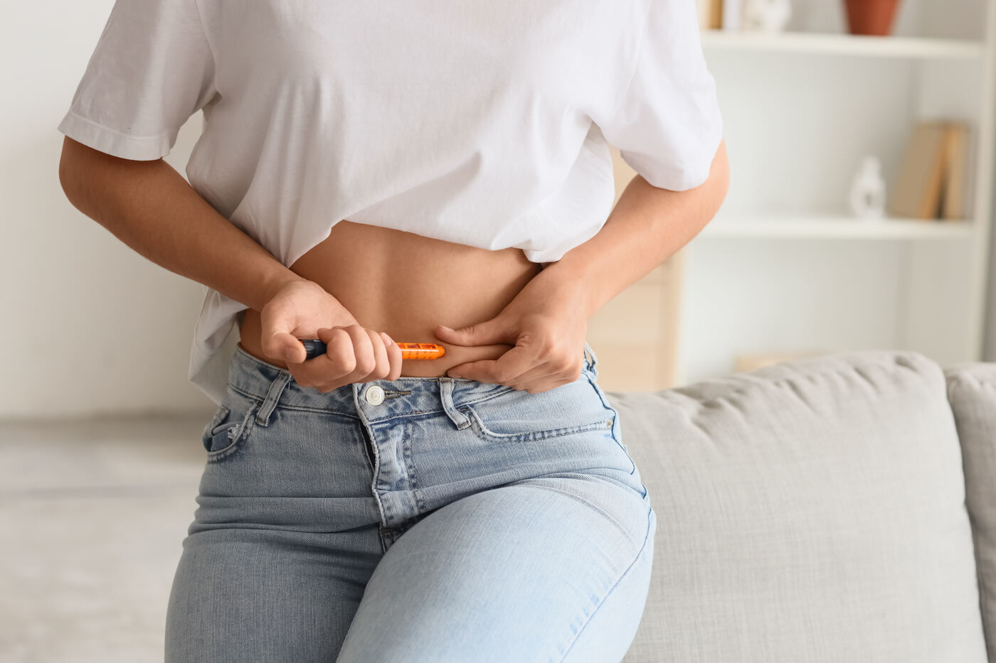 Patient administering a GLP-1 weight loss injection
