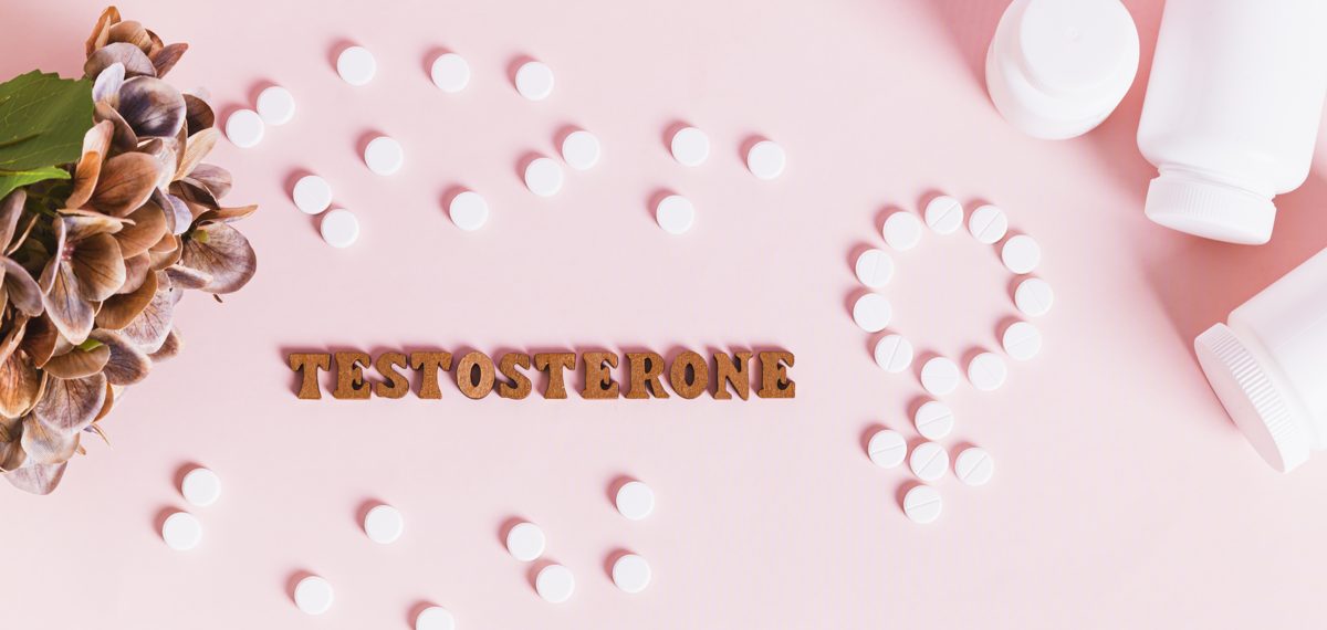 Testosterone spelled in letters beside pills arranged in the female symbol